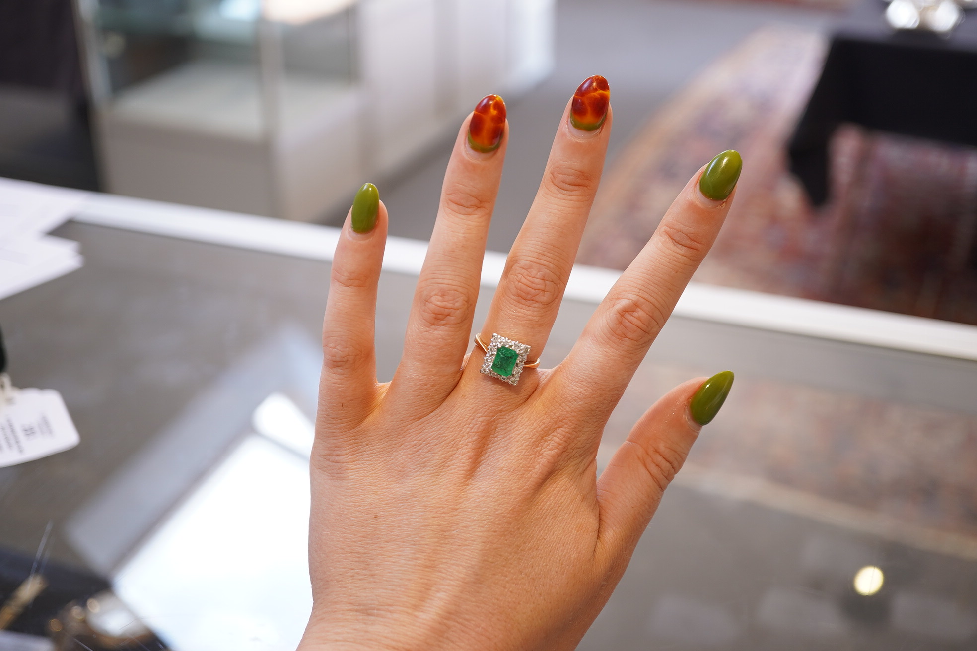 An emerald and diamond ring